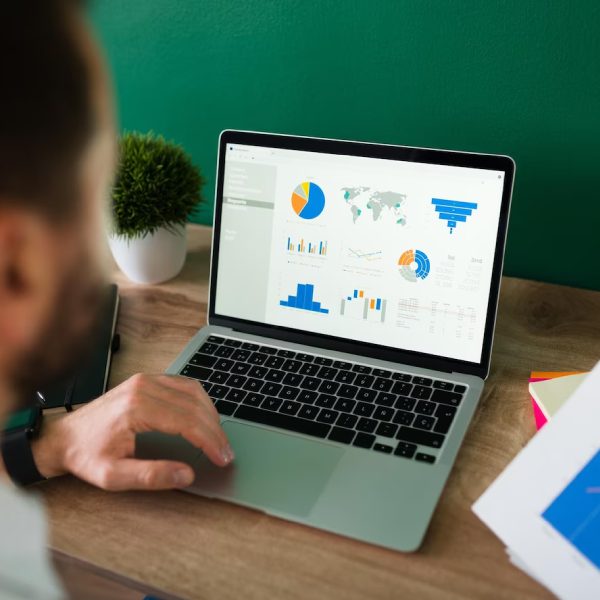 ear-view-young-man-working-his-laptop-looking-work-report-graphs